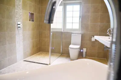 a bathroom with a tub and a toilet and a sink at Ransom Lodge in Chappel