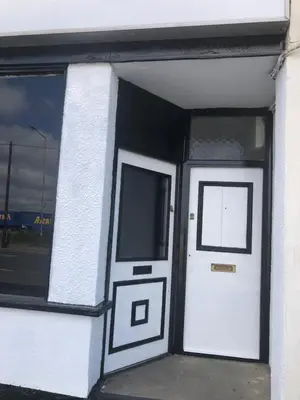 a white building with a white door and windows at AC Lounge 125 in Rochford