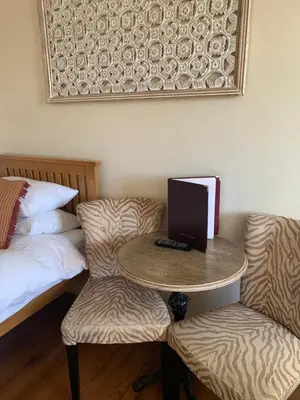 a room with a table with a laptop and two chairs at Parkview Guesthouse in Cambridge