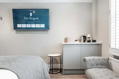 a bedroom with a bed and a tv on the wall at The Regent Aparthotel in Cambridge