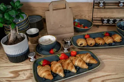 three plates of pastries and strawberries on a table at The Regent Aparthotel in Cambridge