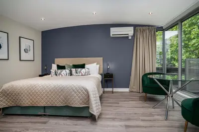a bedroom with a bed and a glass table at The Regent Aparthotel in Cambridge