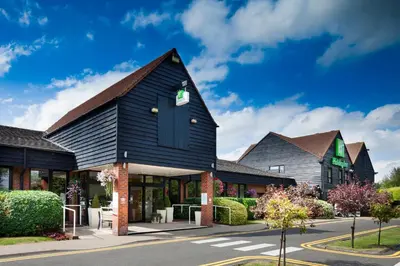 a house with a black roof at Holiday Inn Cambridge by IHG in Cambridge