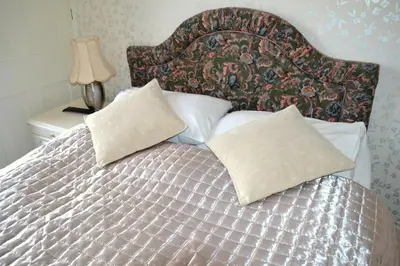 a bed with two pillows on top of it at Ely Guest House in Ely