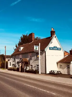 a white building on the side of a street at The Cherry Tree in Woodbridge
