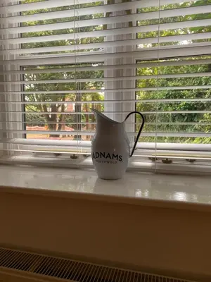 a white vase sitting on a window sill at The Cherry Tree in Woodbridge
