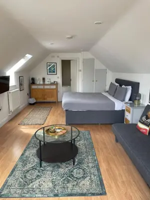a living room with a bed and a couch at The Cherry Tree in Woodbridge