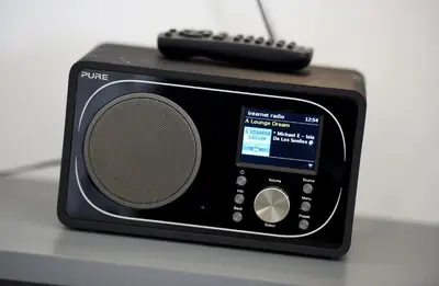 a radio with a remote control sitting on top of it at Tuddenham Mill Luxury Hotel in Tuddenham