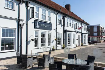 a building with a table and chairs in front of it at Kingscliff, Holland on Sea in Clacton-on-Sea