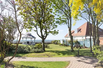 a park with a gazebo and trees at Kingscliff, Holland on Sea in Clacton-on-Sea