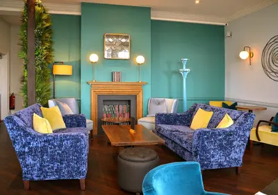 a living room with two couches and a fireplace at Kingscliff, Holland on Sea in Clacton-on-Sea