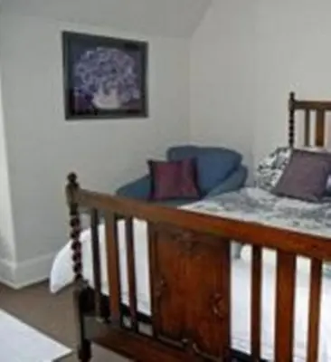 a bed with pillows on it in a room at The Castle Bar ROOM ONLY in Cambridge