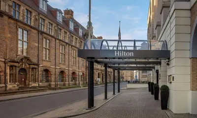a building with a sign that reads filton on a street at Hilton Cambridge City Centre in Cambridge