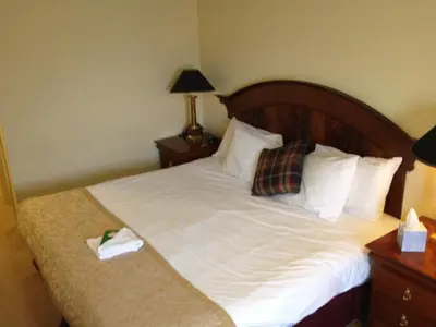 a bedroom with a bed with white sheets and pillows at The Olde Windmill Inn in Great Cressingham