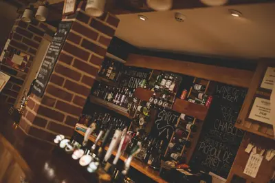 a bar with lots of bottles of alcohol at The Kings Head in New Buckenham