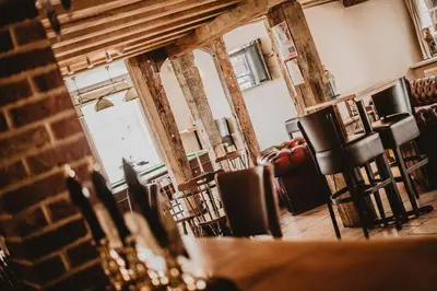 a view of a room with chairs and a mirror at The Kings Head in New Buckenham