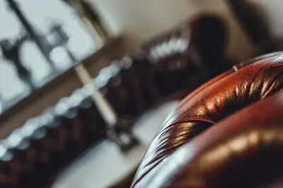 a close up of a chair with a clock in the background at The Kings Head in New Buckenham