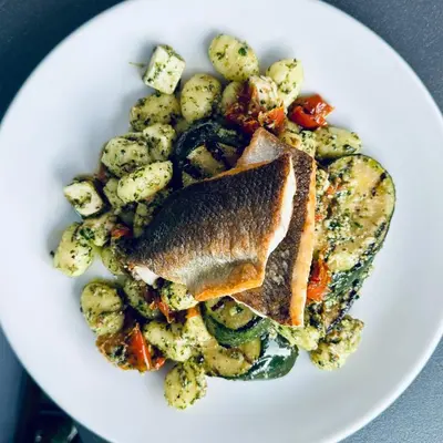 a plate of food with a fish and potatoes at Seckford Hall Hotel & Spa in Woodbridge