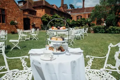 a white table with a plate of food on it at Seckford Hall Hotel & Spa in Woodbridge