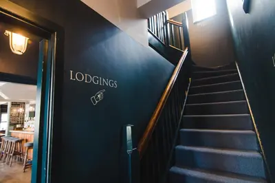 a staircase in a restaurant with a blue wall at The Waterman in Cambridge