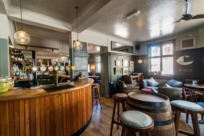 a bar in a pub with stools at The Waterman in Cambridge