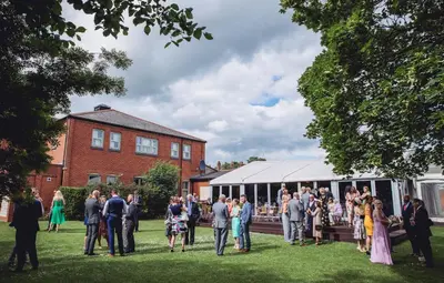 a group of people standing around in the grass at The Rochford Hotel in Southend-on-Sea