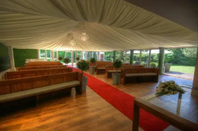 a large room with chairs and a red carpet at The Rochford Hotel in Southend-on-Sea