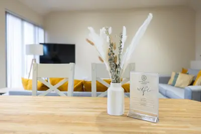a white vase with flowers in it on a table at White House Lodges in Heveningham