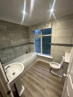 a bathroom with a sink and a tub and a toilet at Cambridge Bed & Breakfast in Cambridge