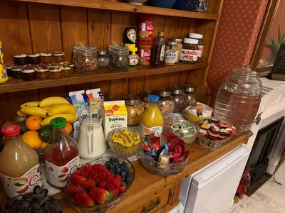 a counter with fruit and other food items on it at Cambridge Bed & Breakfast in Cambridge