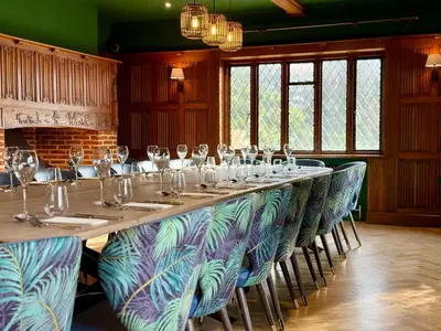a long long table with chairs and wine glasses at Great Hallingbury Manor & Lodges London Stansted in Bishops Stortford