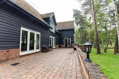 a house with a brick walkway next to a building at Great Hallingbury Manor & Lodges London Stansted in Bishops Stortford