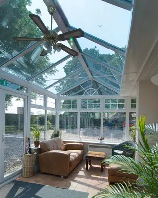 a conservatory with a ceiling with a ceiling fan at Sherbourne House in Attleborough