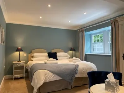 a bedroom with two beds and a window at Sherbourne House in Attleborough