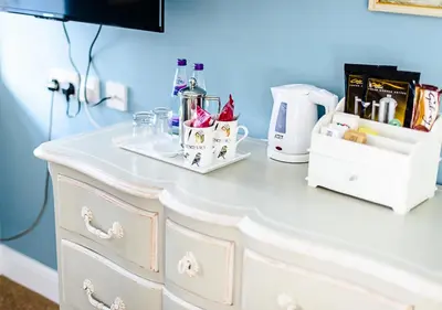 a white dresser in a room with a counter at Sherbourne House in Attleborough