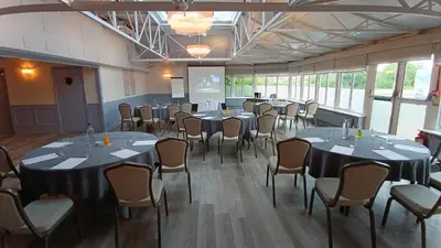 a conference room with tables and chairs in it at Pontlands Park Hotel in Chelmsford