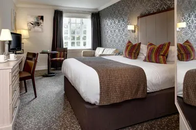 a hotel room with a large bed and a desk at Ivy Hill Hotel, BW Signature Collection in Chelmsford