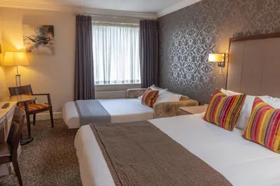 a hotel room with two beds and a desk at Ivy Hill Hotel, BW Signature Collection in Chelmsford