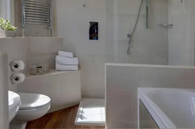 a white bathroom with a toilet and a sink at Ivy Hill Hotel, BW Signature Collection in Chelmsford