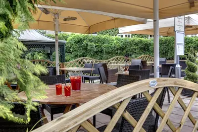 a wooden table with drinks on a patio at Ivy Hill Hotel, BW Signature Collection in Chelmsford
