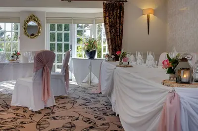 a set of tables in a room with white table cloth at Ivy Hill Hotel, BW Signature Collection in Chelmsford