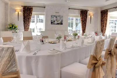 a dining room with a table with white tablecloths at Ivy Hill Hotel, BW Signature Collection in Chelmsford