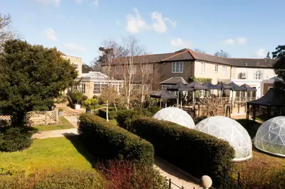 a garden with domes and bushes in front of a building at Ivy Hill Hotel, BW Signature Collection in Chelmsford