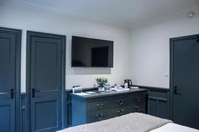 a bedroom with a bed and a sink and a tv at J.D.Young in Harleston