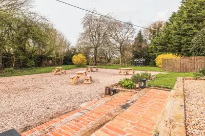 a group of picnic tables in a park at The Auberge in Yaxley