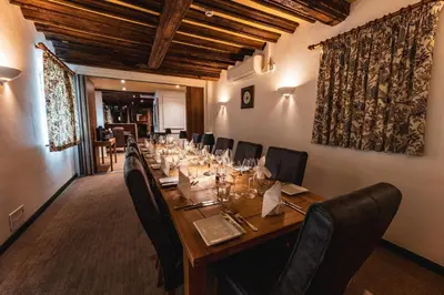 a dining room with a long table and chairs at The Auberge in Yaxley