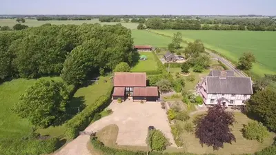 an aerial view of a house with a large yard at Corner Farm in Halesworth