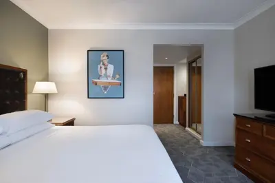 a hotel room with a bed and a television at Delta Hotels by Marriott Waltham Abbey in Waltham Abbey