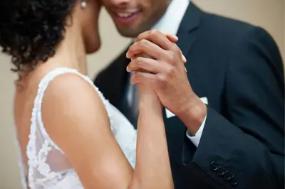 a bride and groom holding their hands together at Delta Hotels by Marriott Waltham Abbey in Waltham Abbey