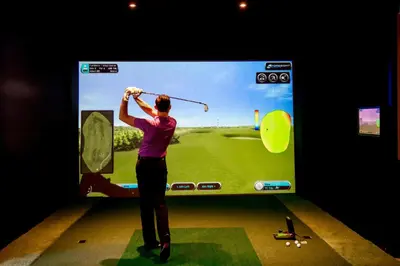 a man playing a video game on a television screen at Hanbury Manor Marriott Hotel & Country Club in Ware